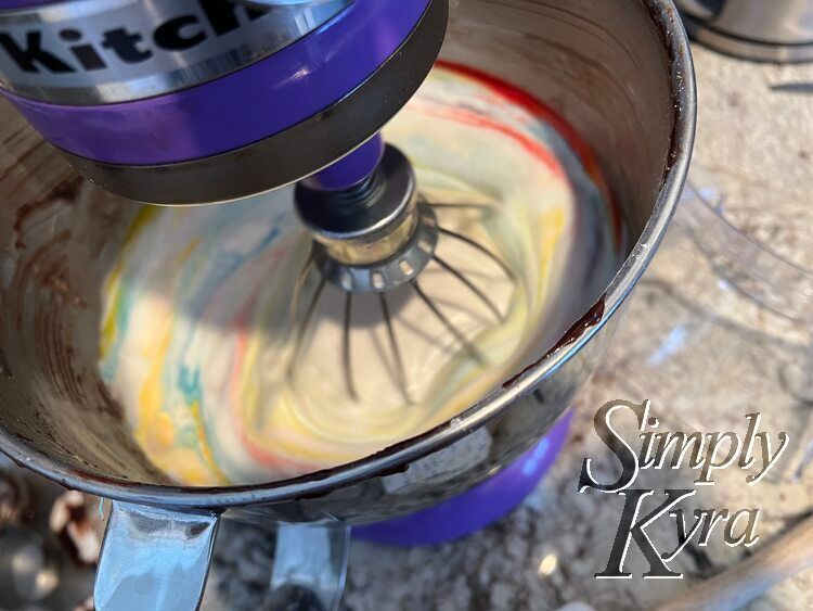 Image shows the bowl of a stand mixer looking down with the whisk down, turned on, and blurred. The center has turned browny greenish but the outside still looks great.