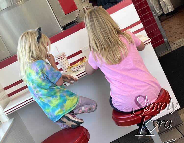 Kids enjoying their burger and fries together.