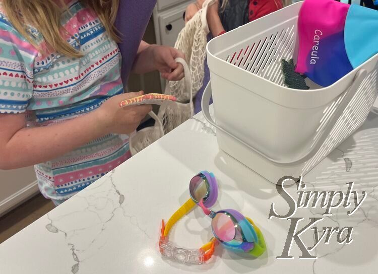 Image shows the girls behind the basket holding the bags and putting starfish inside them.