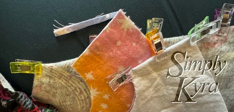 Three stages of the seam is shown on the little sleeve edge. Center is trimmed while the outer two are flipped with the right finger pressed and clipped more.