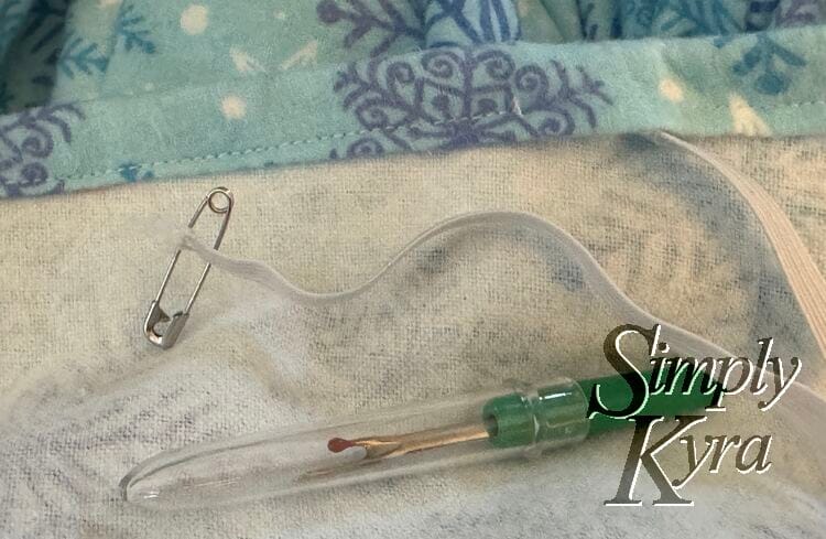 Seam ripper is done so the lid is back on and the safety pin has been put back through the elastic a bit further in.