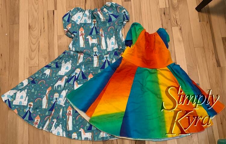 Image shows a flat lay of the front of two dresses highlighting the size difference at that time.