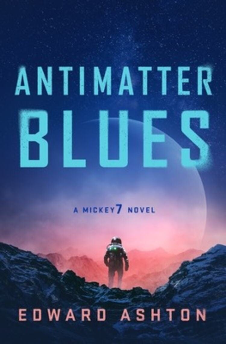 The cover features the title “Antimatter Blues” by Edward Ashton. The cover shows a man in a space suit on a planet with a large moon in the background.