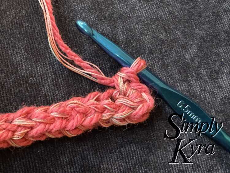 Image shows the end of the first chainless foundation crochet stitch with the reversed side stitched into it. 