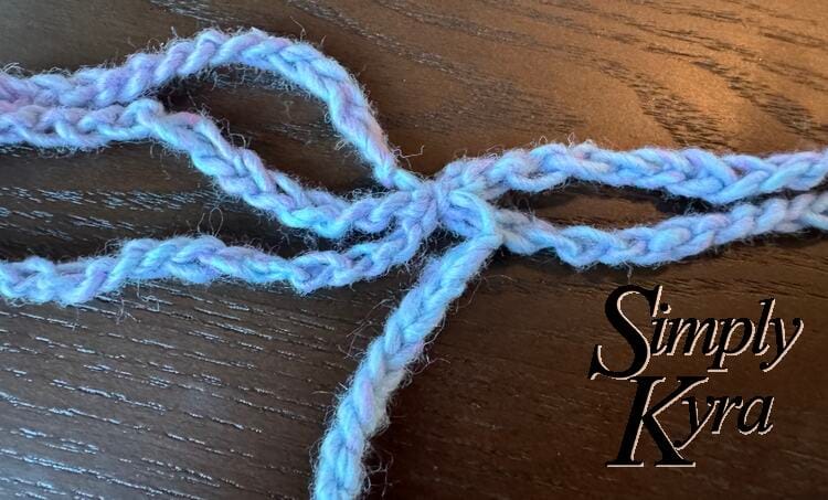 Image shows the center point of all six strands tied together. 
