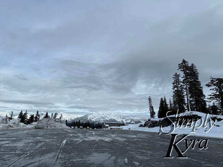 Image shows a view of the plowed parking lot with the mountain in the back.
