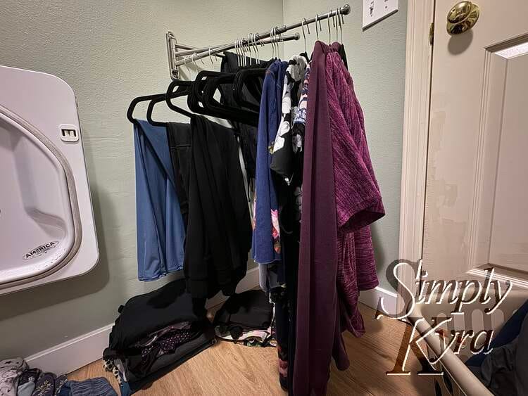 Image shows the laundry room when folding with the basket for Matt's clothing, floor used for folding smaller items, and the rod used for my hanging garments and extra hangers. 