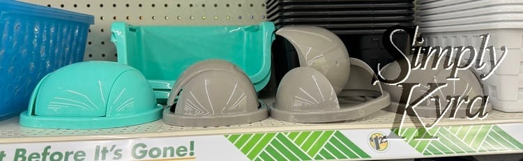 Image shows the swing top garbage lids surrounded by baskets but no bases.