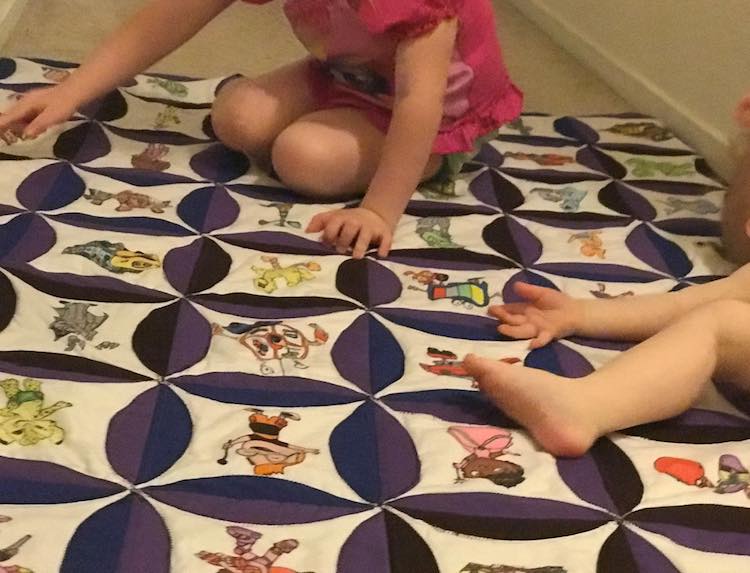 Toddler finding all the characters she recognizes as baby spreads out and rolls around.