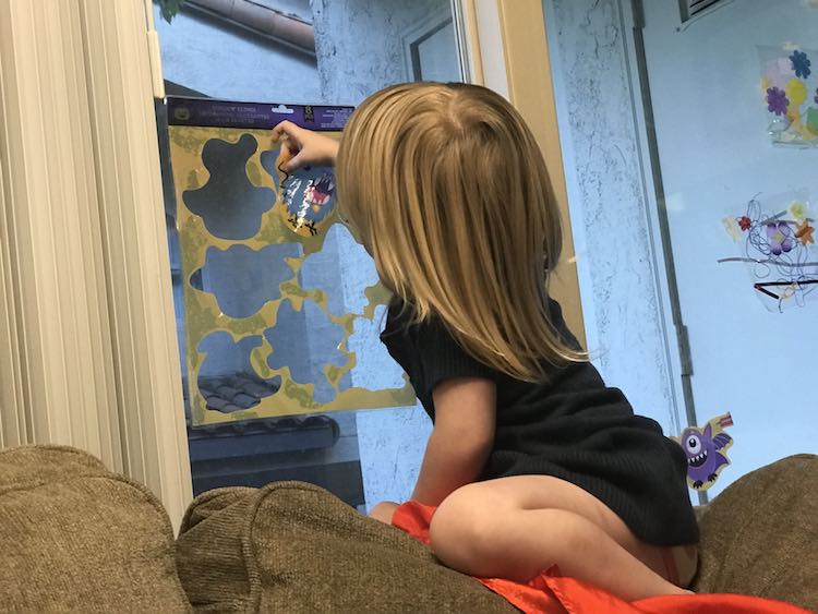 Decided to climb up on the back of the couch and work on her puzzle by herself.