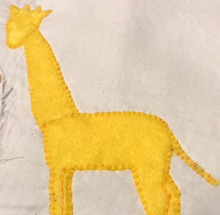 Giraffe sewn to the page.