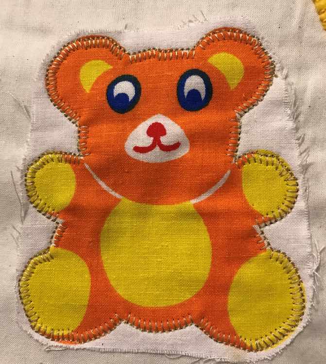Pinned and sewed the teddy bear onto the page.
