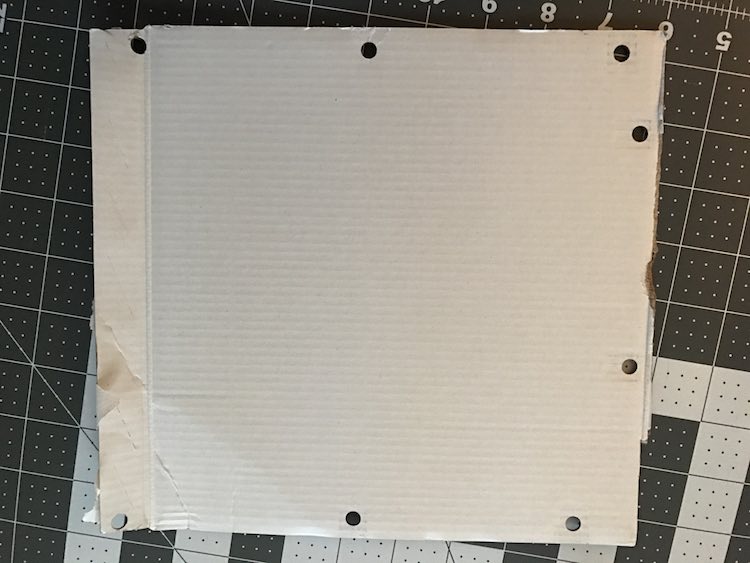 Use a three hole punch to create a template for the grommets.