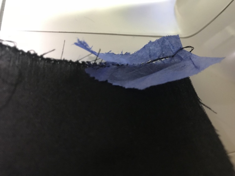 Tissue paper helped sew a single edging on the thin fabric.