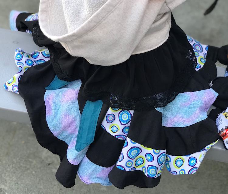 Skirt draped over the picnic bench overlaid with a sweater and lace.