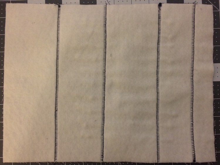 The back of the page just shows the vertical lines where I sewed the purple fabric down. I ignored the top and bottom as it will be sewn together with the reverse side of the page.