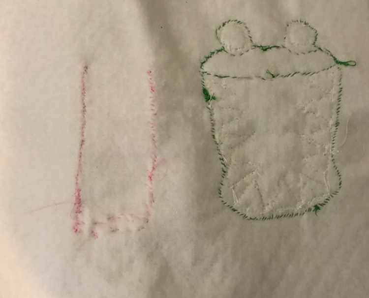 The back of the quiet book page shows the crocodile outline and where I sewed the top of the page along with the outline of where I sewed the cup on.