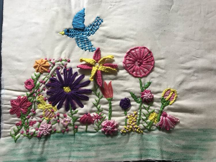 I then filled in the blank spaces in the garden with more stitches and colors. I decided to keep the grass unembellished to compliment the page yet not detract from the garden.