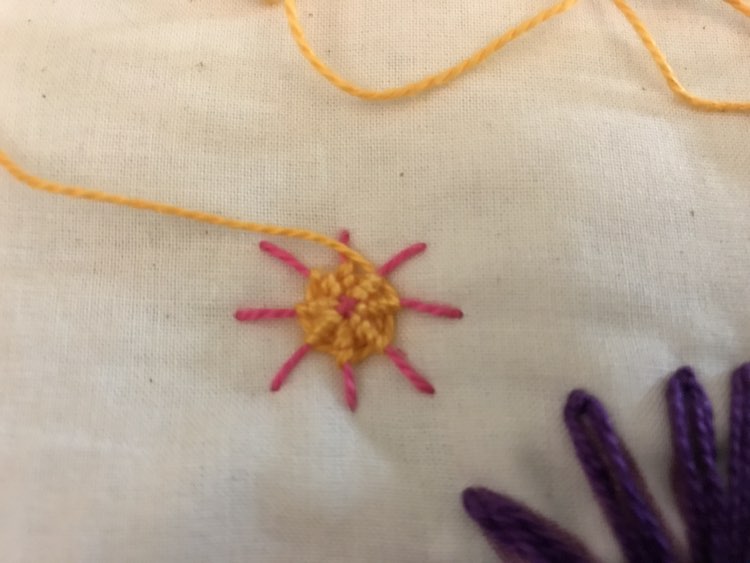 Decided to use a whipped spider web stitch to make a yellow flower with pink poking through the center and edges (with the base stitches).