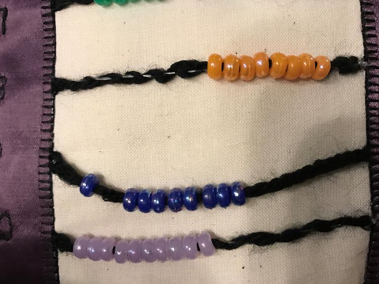 There's already a big difference between the strengthened yarn (with the orange beads) and the rows with only yarn (blue and purple beads).