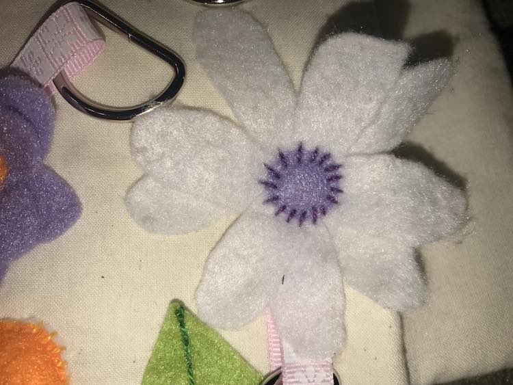 Simple petals with a center purple circle and then attached with simple stitches.