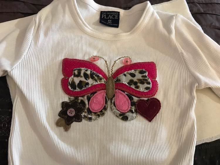 I started with an old shirt I had that Zoey didn't really wear but had a really cool embroidered butterfly on it.