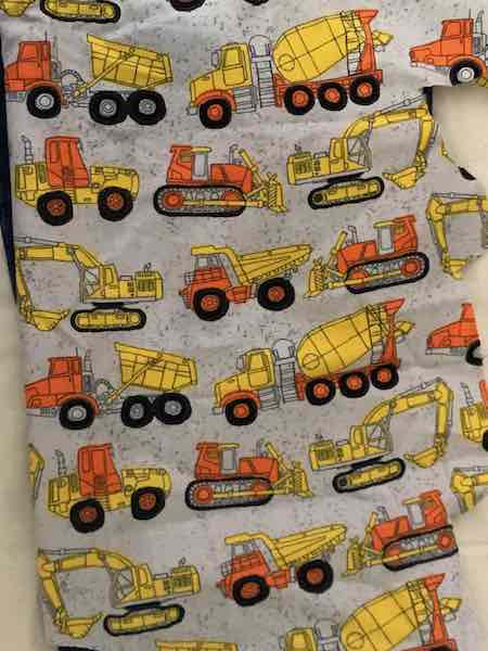 I grabbed our cotton woven construction vehicle fabric and confirmed it was long enough to to stretch the width of the pant legs.