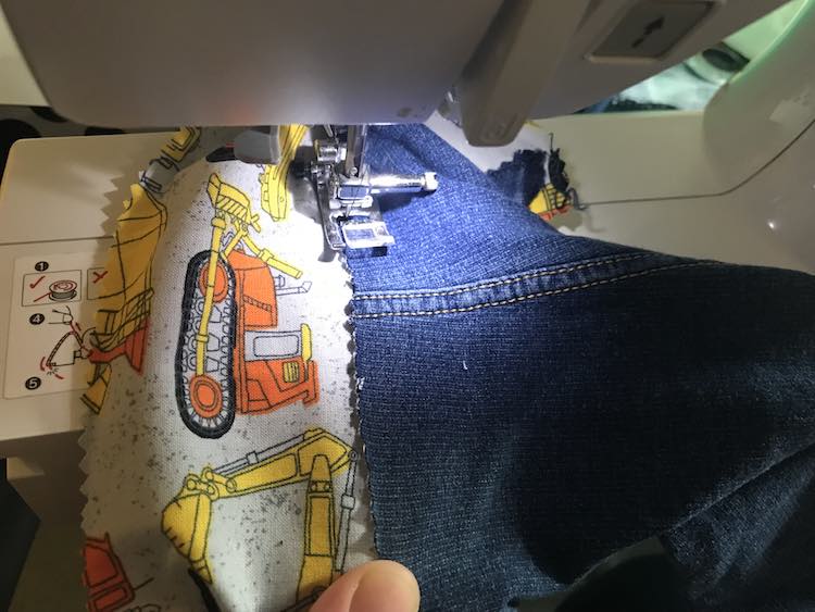 I then kept lining up the jeans as I sewed along making sure to cover up the construction vehicles above the main road. 
