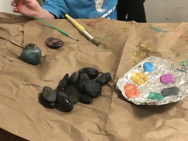 Set out paint brushes, rocks, and paint. We also pull out water to rinse the brushes and paper towel to dry them.