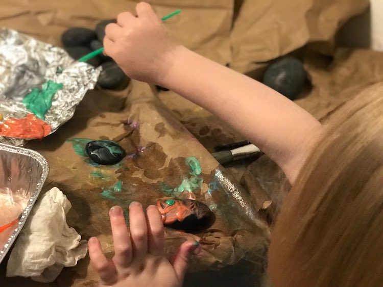 Painting her rocks.