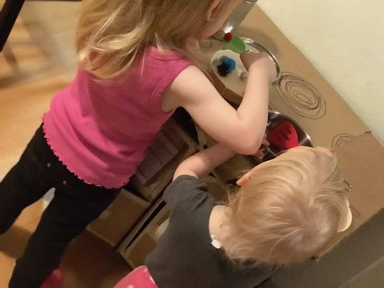 Making pompom food together in their own pots.