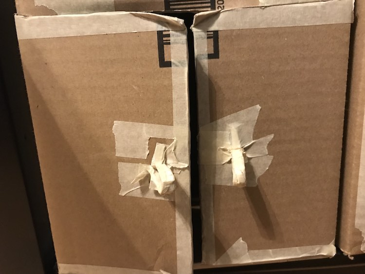 The cupboard was sliced across the top and bottom before being sliced down the center. The resulting two doors then had smaller cardboard tabs attached for handles.