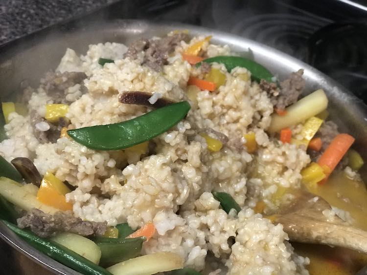 Once the vegetables are cooked add your rice. Break it up and cook until heated through.