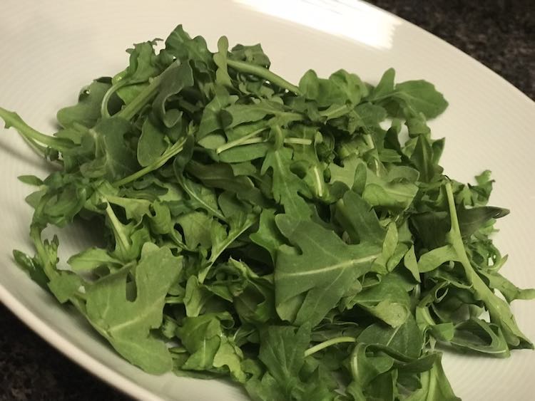Start with your green... in this case baby arugula.