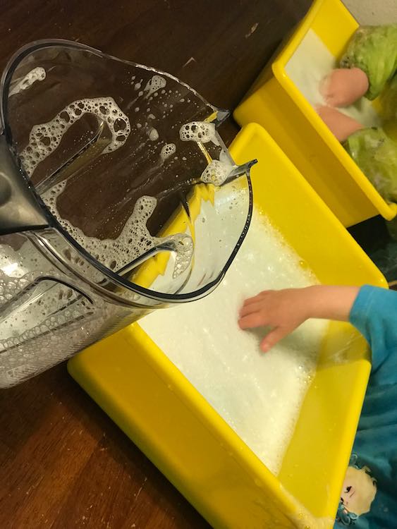 And then pour the tinted bubbles into the sensory bins for bubbly fun.
