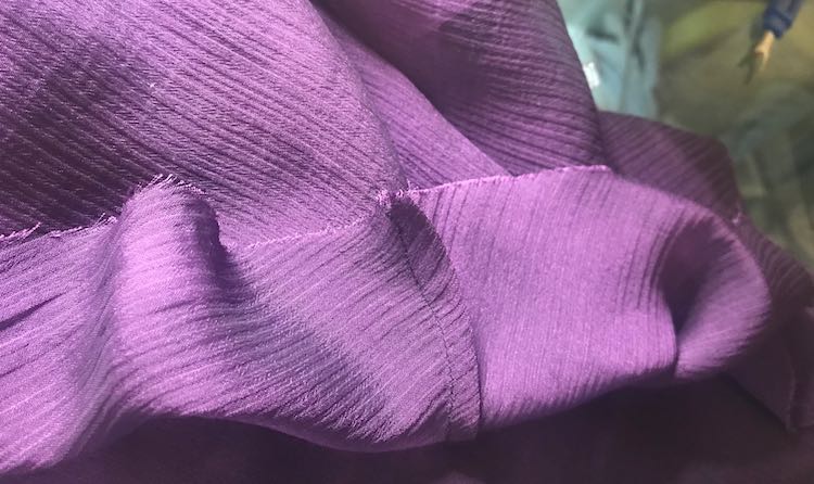 French seam on the inside bottom of the camisole layer.