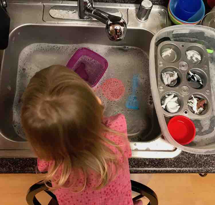 The dirty toys were left in the bin beside the sink and I later added a black colander that fit over the left side of the sink for her to put the 'done' toys.