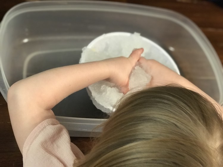 Putting the 'snow' away in a mixing bowl to be plastic wrapped and set aside for the next day.