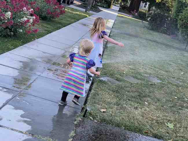 Playing in some sprinklers.