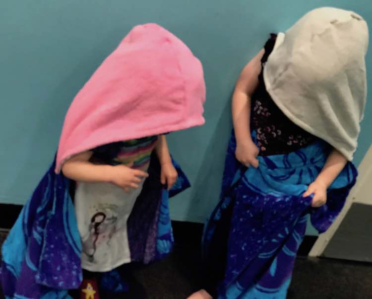 Loving their new towels after getting wet at the discovery museum.