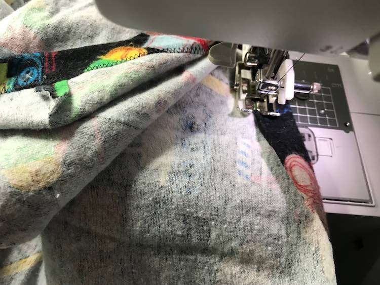 Flip the edge of the sheet over and sew along the edge. This creates a channel for the elastic so make sure it's wide enough. Also be sure to leave an open space to thread the elastic in.