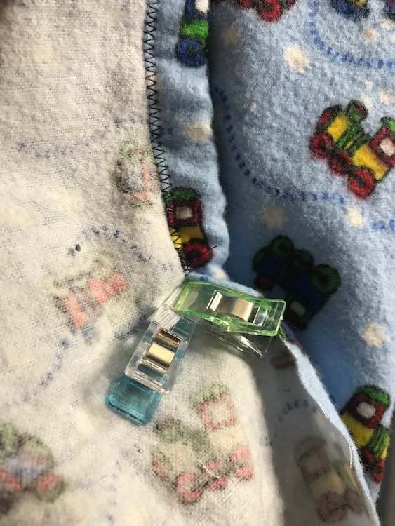 Thread the elastic through from the one side to the other. I used sewing clips to make sure my end wouldn't disappear though you could wait until it's almost gone and then sew it in place before continuing.