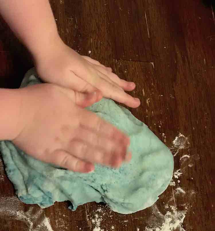 After mixing it together enough that the dye was dispersed through the playdough I handed it to Ada to finish mixing.