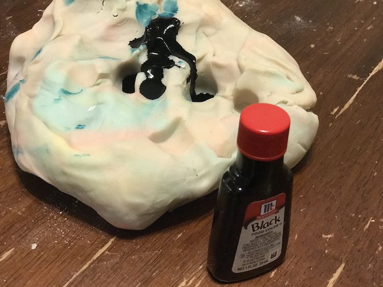 After she was done I added black food dye to the older playdough to turn it into dirt to go with the water and grass.