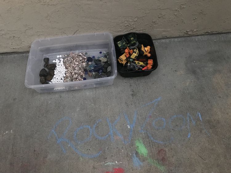 The found our mixed rocks from before and decided to keep the vehicles off to the side so there was more room for the rocks and more room to zoom a single car around.