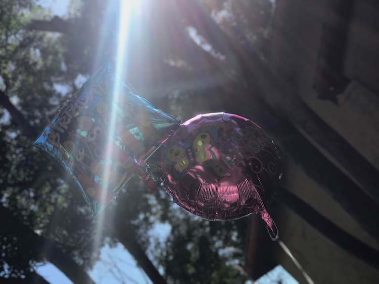 I stole a couple of the balloons in the house to hang up on our deck outside. I just tied the two balloons together then tied them to the deck railing with a big enough loop to easily cut off later.