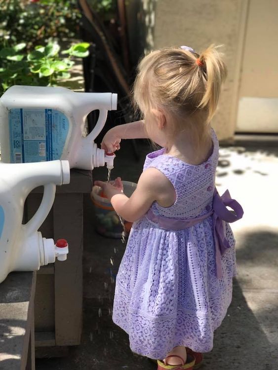 Use empty and rinsed out laundry detergent bottles to contain the water for whenever they want it. You can even not rinse it out for simplest soapy water.