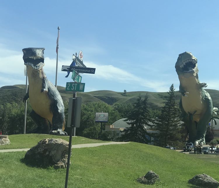 Different vantage point puts both the dinosaurs together by the aptly named street signs.