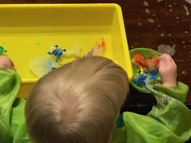 Zoey washing her toys off in water. The minimal bubbles shows me this is the plain water and the bubbles are from rinsing them off of her toys.