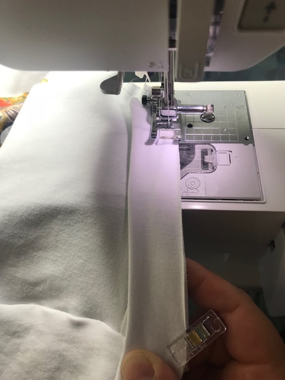Then while you're sewing you can hold it taunt at the next clip so the layers are lined up and the band is stretched. If the clips or pins are further apart you can stretch it at the clip and then grab a section closer to the sewing machine to keep taunt.